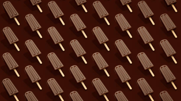 Trendy Summer pattern made with chocolate fudge fudgecicle popsicle ice cream on brown background with clipping path. Minimal summer concept. stock photo