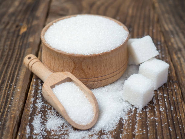 istock Stack of sugar cubes and granulated sugar in a wooden scoop 1400303868