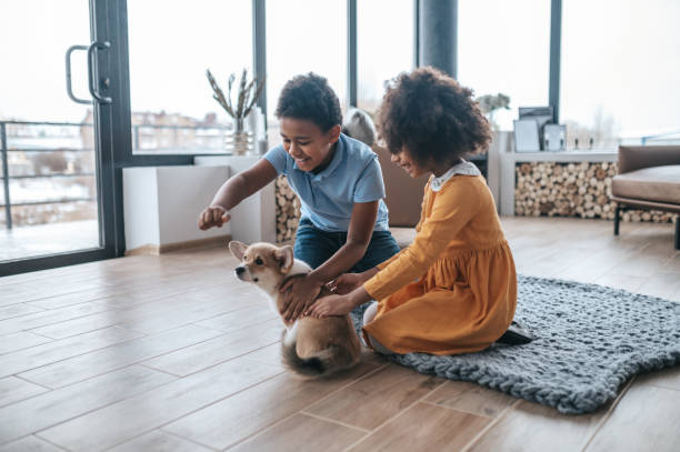 istock Kids training the puppy and looking excited 1400305329