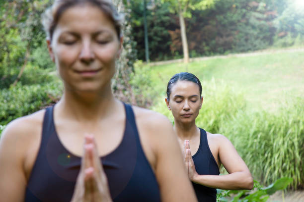 istock Women Meditating In Nature 1400306405