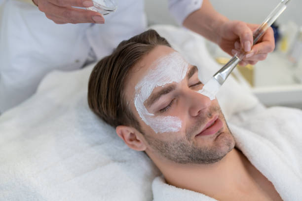istock Close up of a man with a moisturizing mask on his face 1400307836