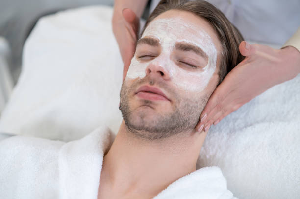 istock Young man with mask on his face having neck massage 1400307862