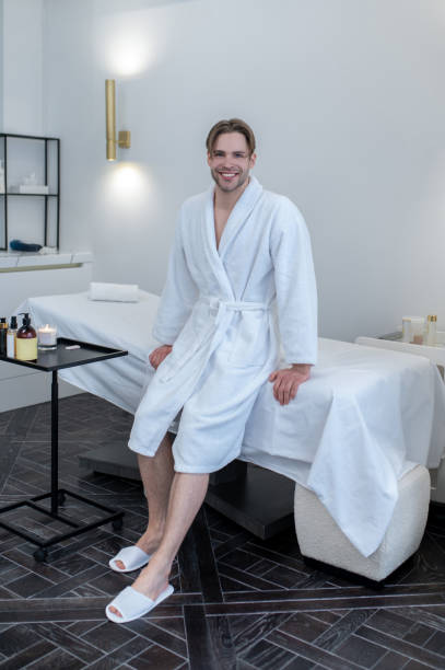 istock A young man in a white robe in a spa salon 1400307874