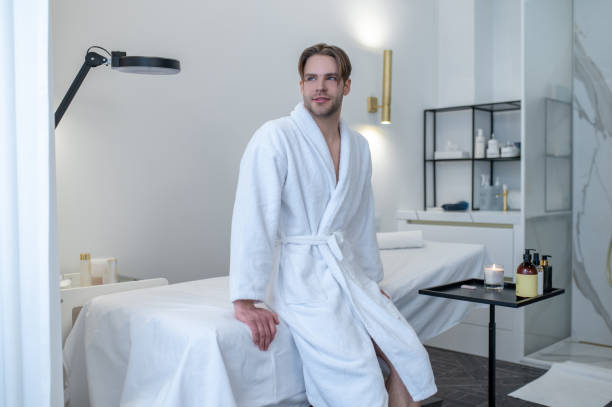 istock A young man in a white robe in a spa salon 1400307894