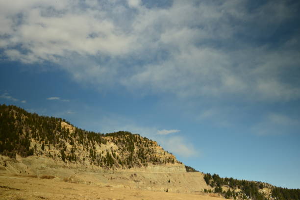 istock Soft Clouds And Blue Sky Against Large Mountain 1400313397