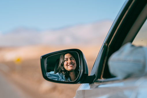 Woman traveling by car in the Atacama Desert