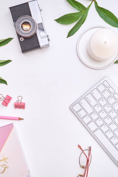 istock Feminine blogger workplace with notepad, keyboard on a white table. Flat lay banner, template for blog 1400315503