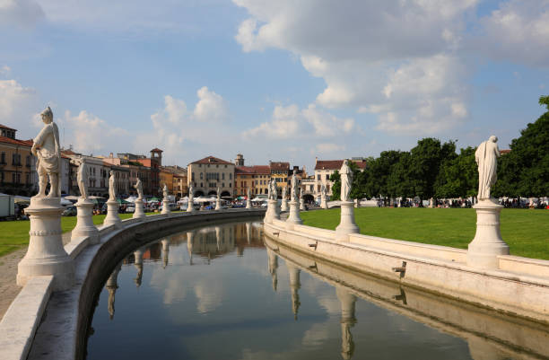 Large public park in Padua called Prato della Valle with the statues and the water canal