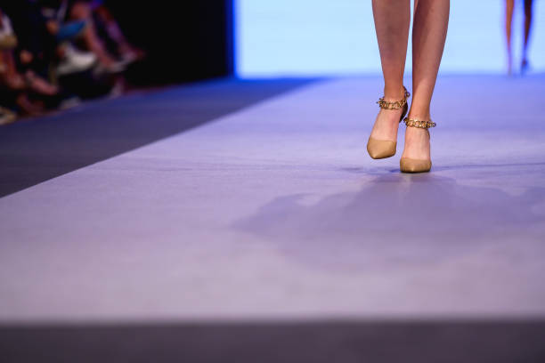 istock Model with beautiful high-heeled shoes on the catwalk 1400316568