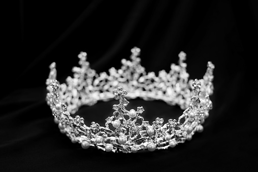 Crown with diamonds, crystals and pearl on black luxury background. Black and white