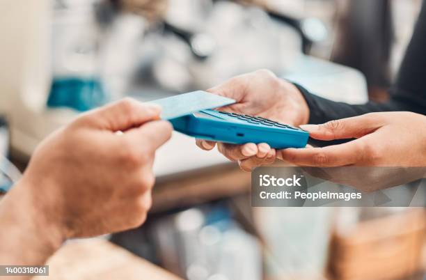 Closeup Of A Clerk Accepting A Contactless Credit Card Payment Using Nfc Technology From A Customer In A Cafe Or Store Hands Of Man Tapping Card Machine Reader To Process Cashless Transaction For A Purchase In A Shop Stock Photo - Download Image Now