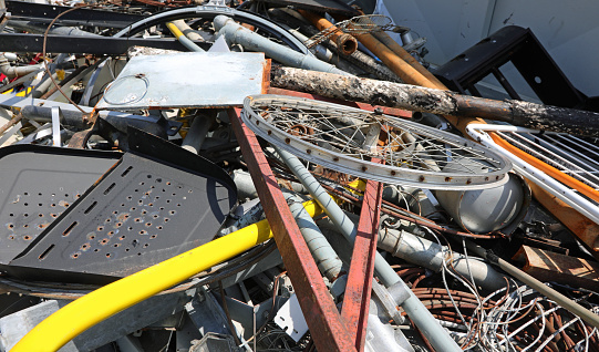 Electrical and electronic waste disposed of in a recycling center, close up shot. E-waste, repair, reduce, recycle concept.