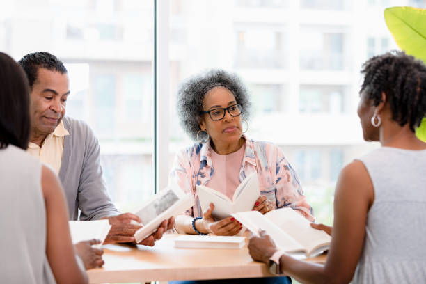 istock Woman listens and thinks about ideas presented in book club 1400319229