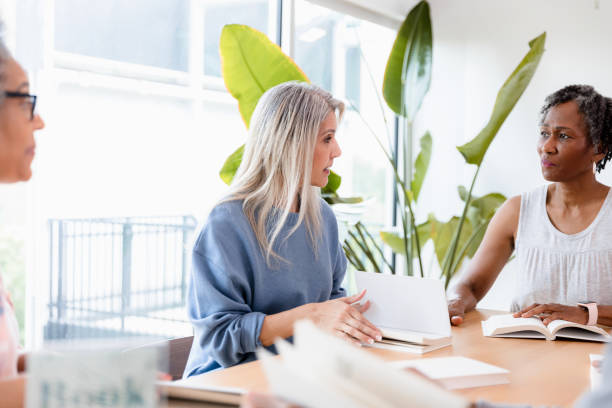 istock Two mature women have difference of opinion about book 1400319237