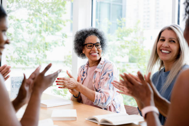 istock Diverse women smile and clap during meeting 1400319244