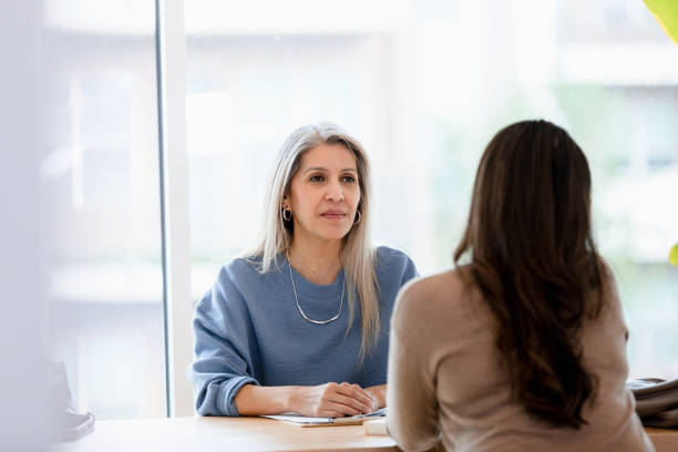 istock Serious female manager interviews unrecognizable woman 1400319251