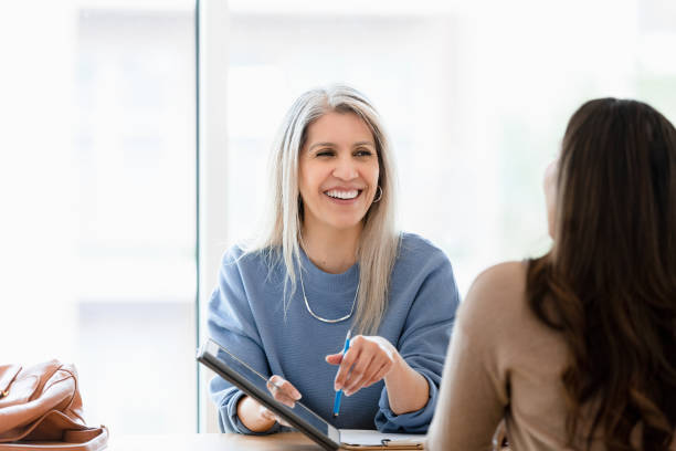 istock Mature female financial advisor meets with female client 1400319258