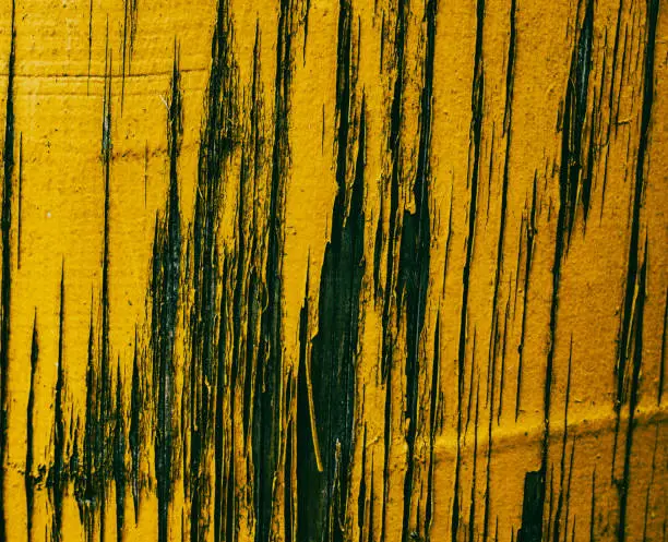 Photo of a yellow wall with scratches. torn paint