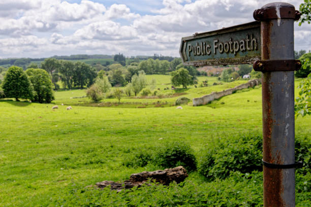 istock Footpath sign pointing over a traditional hay meadow in Chipping Campden 1400323322