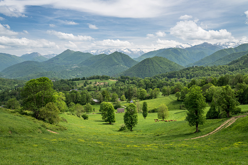 Green mountain landscape with cloudy sky in Ariege Pyrenees France