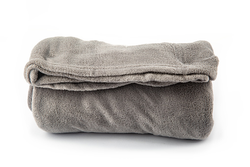 Gray rolled microfiber blanket isolated over white background