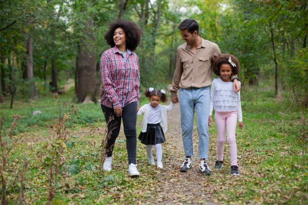 istock Happy family walking along a path in the woods 1400331906