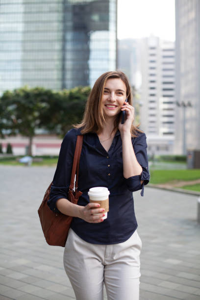 istock Young woman using phone and going up on stairs Hong Kong 1400337433