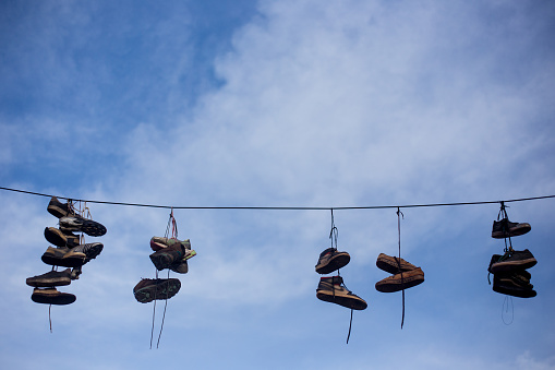 sneakers and flying shoes, hanging from the threads of light