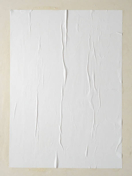 istock Blank white wheatpaste glued paper poster mockup on white wall background 1400338777