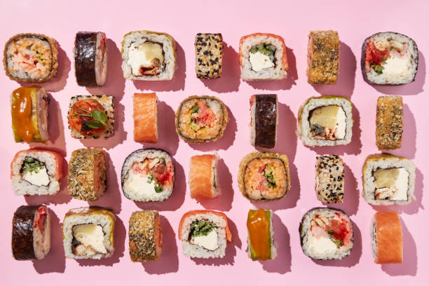 istock Various sushi rolls on pink background, top view. 1400339137