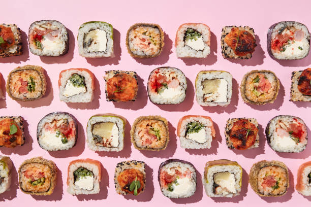 istock Various sushi rolls on pink background, top view. 1400339138