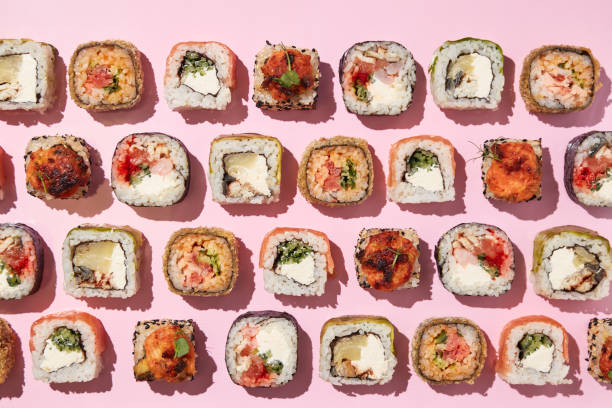 istock Various sushi rolls on pink background, top view. 1400339142