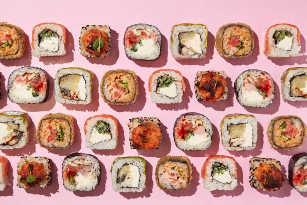 istock Various sushi rolls on pink background, top view. 1400339157