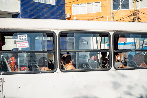 Salvador, Bahia, Brazil - November 01, 2021: Passengers wearing a protective mask against covid-19 inside the bus in the city of Salvador, Bahia.