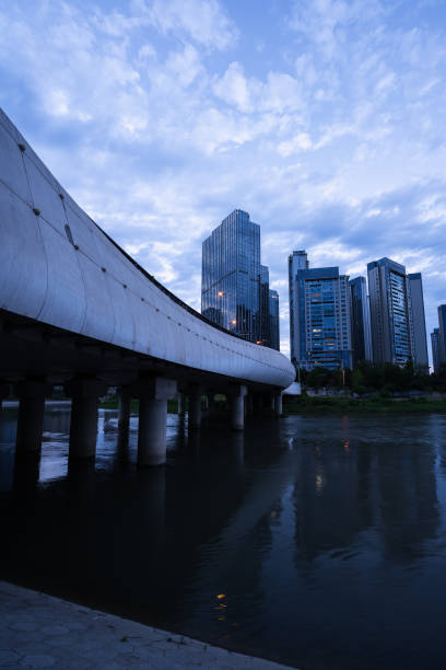 istock Modern buildings and bridges along the river at dusk 1400344166