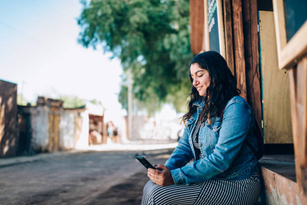 istock Young Chilean woman using cell phone 1400345701