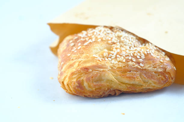 fresh bagel bread in a paper on table ,