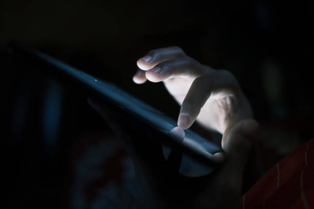 istock Close up of young man hand using smart phone at night 1400349912