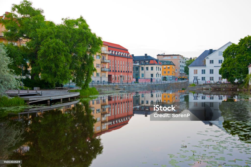 Fyris River Colorful buildings are mirrored in the calm Fyris River, Uppsala, Sweden. City Stock Photo