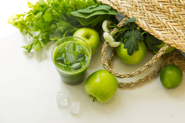 Creative image. Green vegetable basket, green healthy fruit and vegetable and green fruit and vegetable mixed juice - stock photo Suitable for organic food, beverage, snack, fruit and vegetable growing, food processing, food distribution, kitchen supplies, tableware, kitchenware, kitchen appliances, recipes, menus, ordering programs, hotels, restaurants, fast food restaurants, bar, print advertising. Still Life. basket healthy eating vegetarian food studio shot stock pictures, royalty-free photos & images