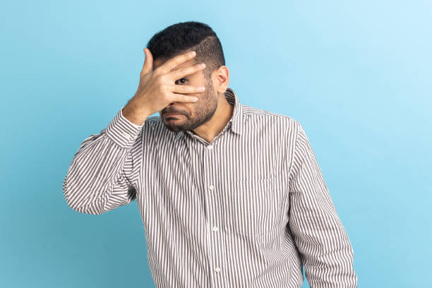 istock Businessman looking through fingers, peeking with curious face, having suspicious, watching secrets. 1400354551