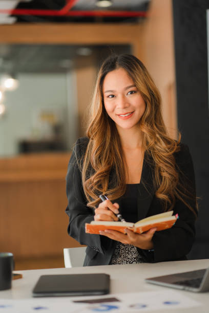 istock Asian businesswoman working on documents and laptops, making reports, account analysis, reports, real estate investment data. financial system concept and tax vertical picture 1400354585