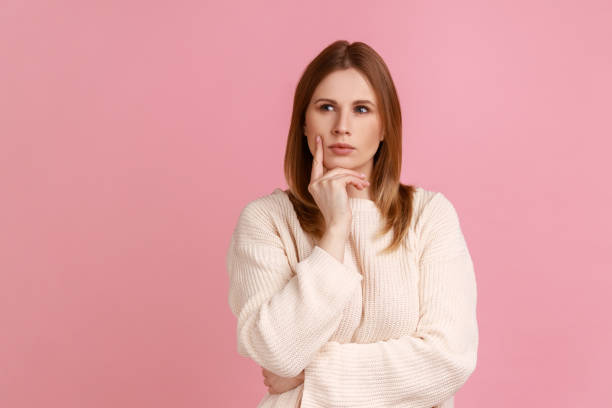 istock Woman holding chin, pondering idea, planning strategy, musing and solving difficult question in mind 1400355525