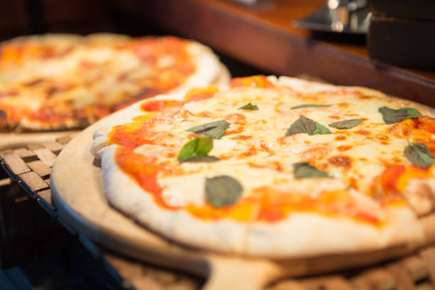 istock Selective focus of pizza in wood tray on the buffet table 1400362478