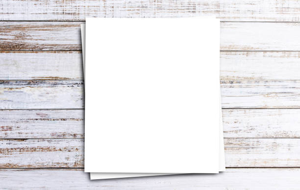 istock Top view with white paper on wooden table background 1400362479