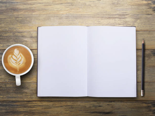 istock Office desk with blank notebook and coffee on wood table background. 1400363162