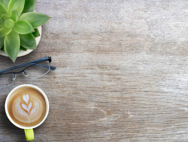 istock Coffee,glasses and flower on wood table background. Top view with copy space. 1400363307
