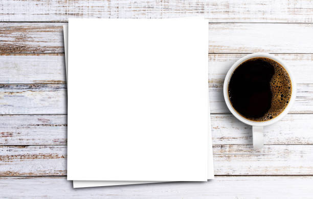 istock Top view with white paper and coffee on wooden table background 1400363363