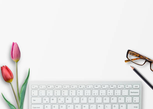istock Top view with keyboard,glasses,pink tulip and pencil on white table background 1400364265