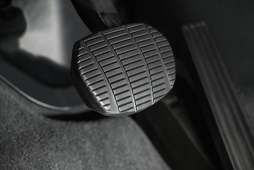 Angled closeup view of the brake pedal in a modern car.